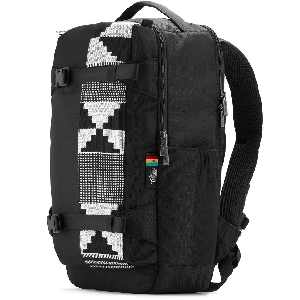 Side view of a black backpack with a black and grey pattern on the right-hand side. You can see the carrying handle and the shoulder straps at the top. 
