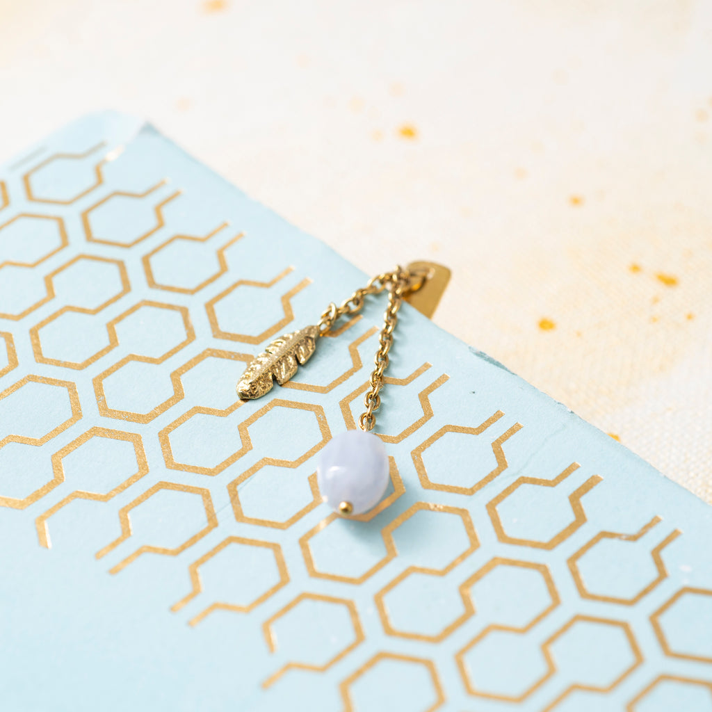 Close-up of the brass spring and the Blue Lace Agate pendant