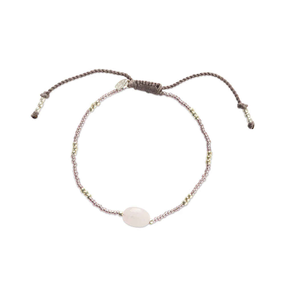 Overall view of the rose quartz bracelet with a sliding knot and a small pendant.