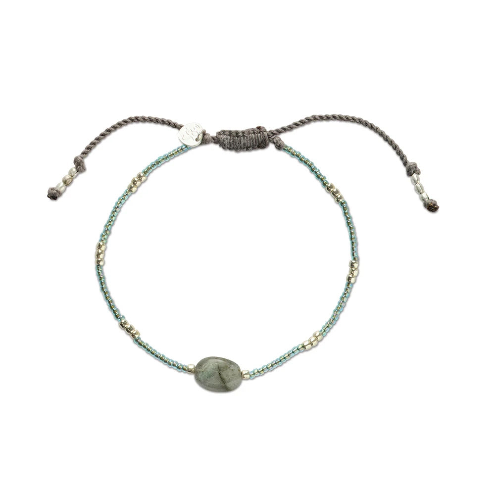 A full view of the bracelet, showing the sliding knots and the small pendant.