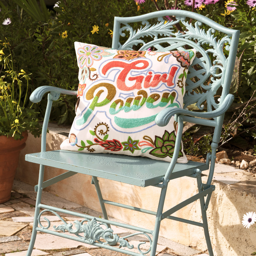 A mood board decorated with a cushion on a garden chair.