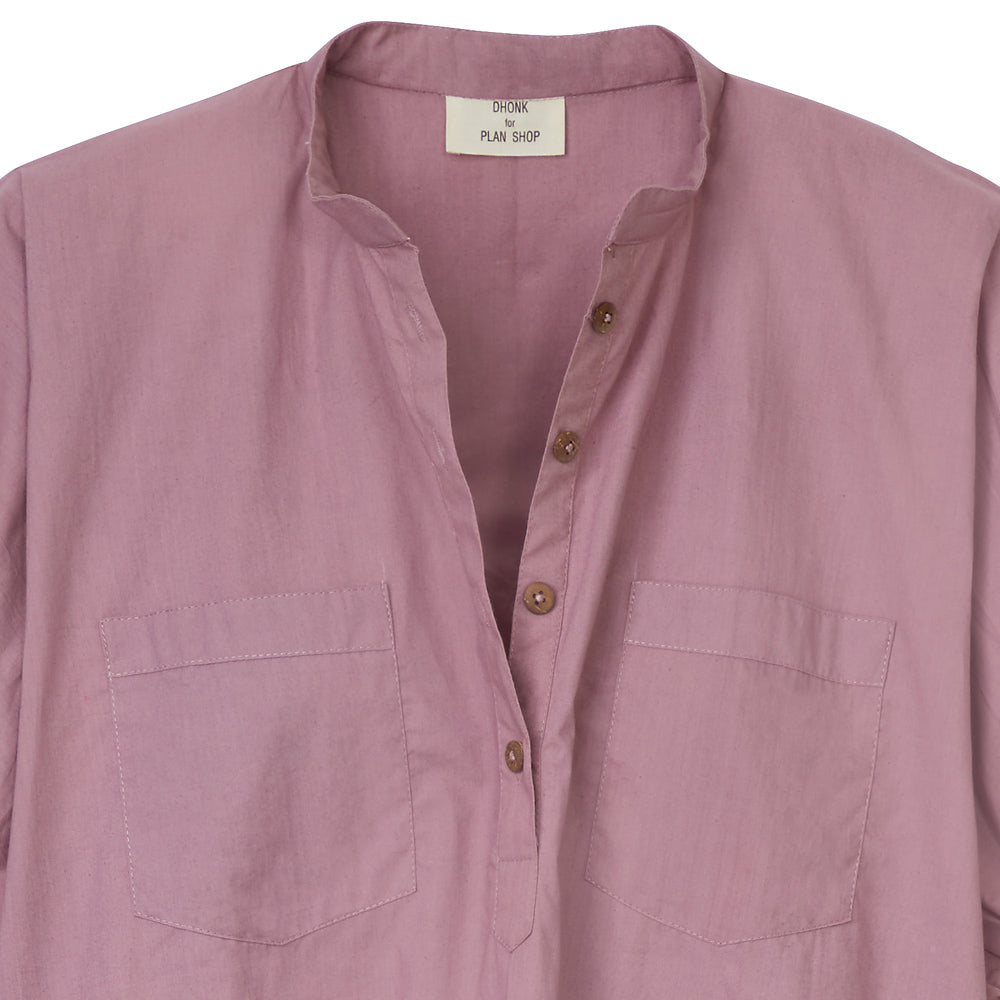 Close-up of the aubergine blouse showing the stand-up collar and button placket with brown buttons.