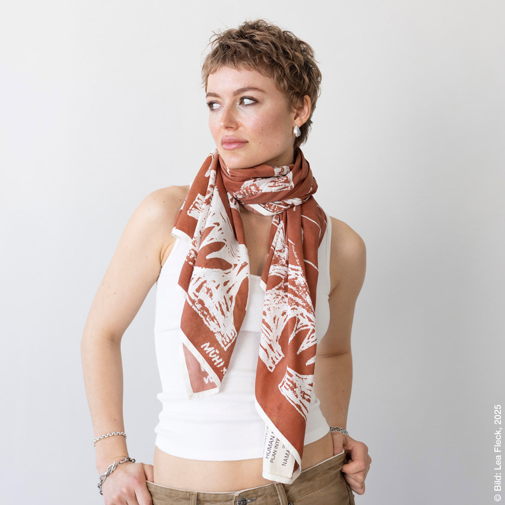 Woman with a scarf draped around her neck.