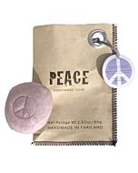 grey soap with a peace sign lies on the left on a brown paper bag with the inscription PEACE, on the top right is a grey peace pendant

