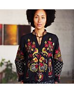 Frau trägt eine schwarze Bluse mit bunt besticktem Blumenmuster