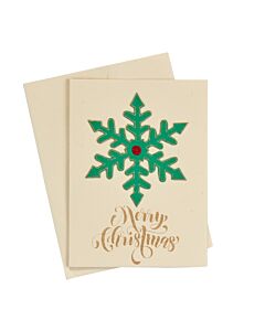 beige Weihnachtskarte mit gezeichnetem grünen Eiskristall, darunter in goldener Schrift "Merry Christmas"